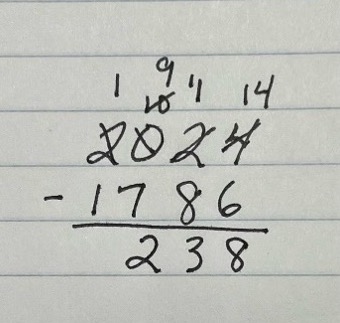 A handwritten math problem shows that 2024 minus 1786 equals 238.
