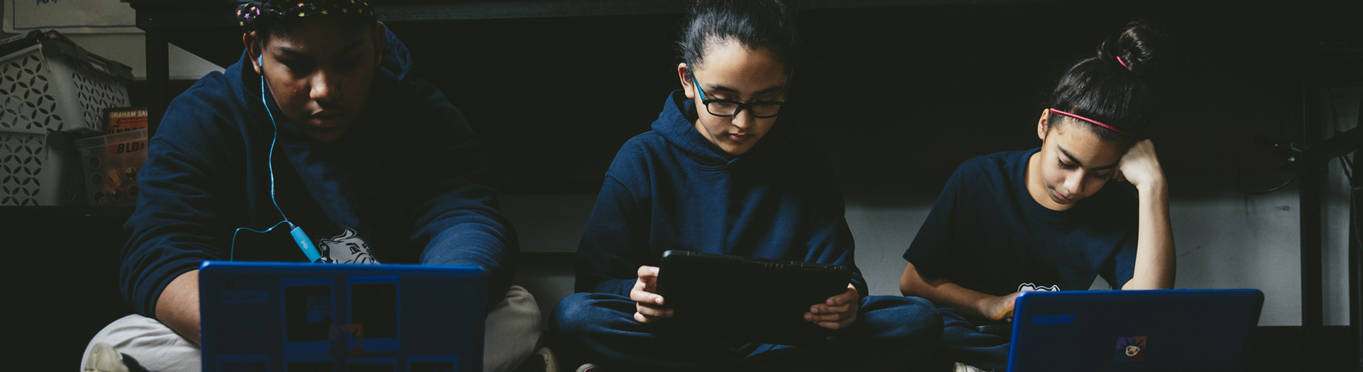 Three students on devices