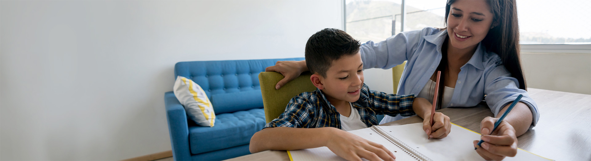 Mother helping son with homework.