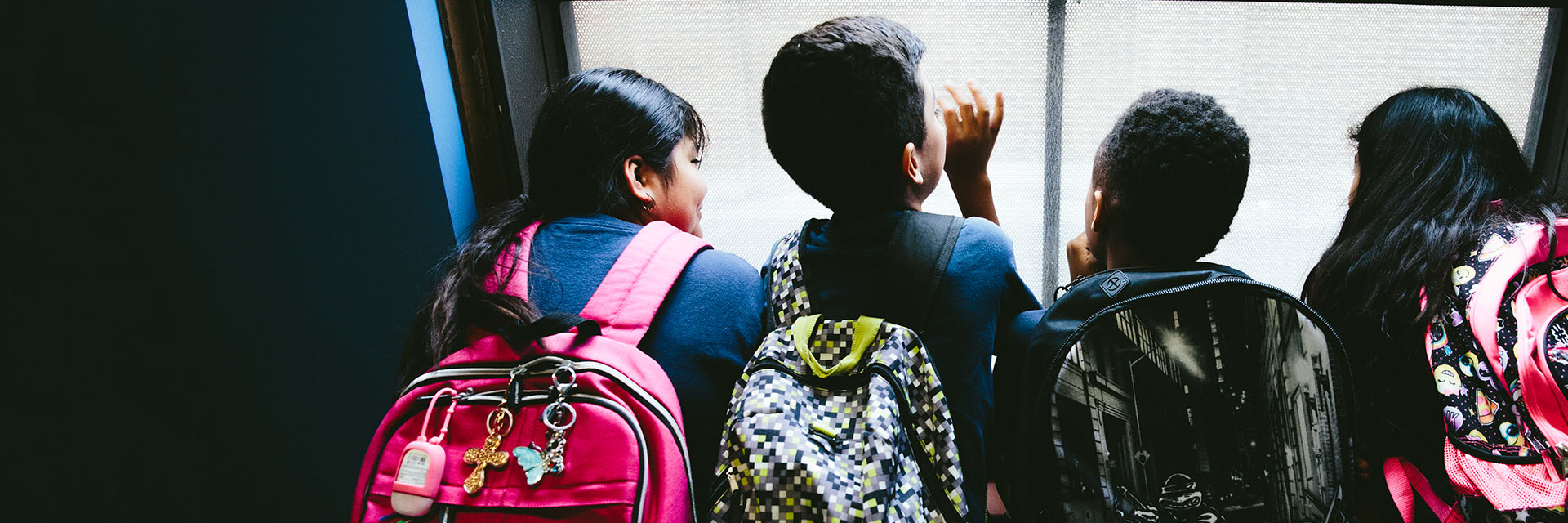 Students looking outside window.