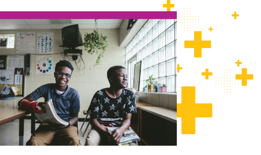 Two students sitting in classroom.