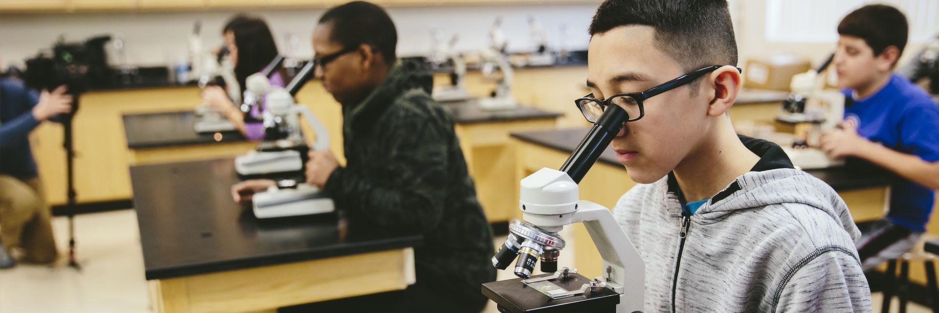 Students looking through microscopes.