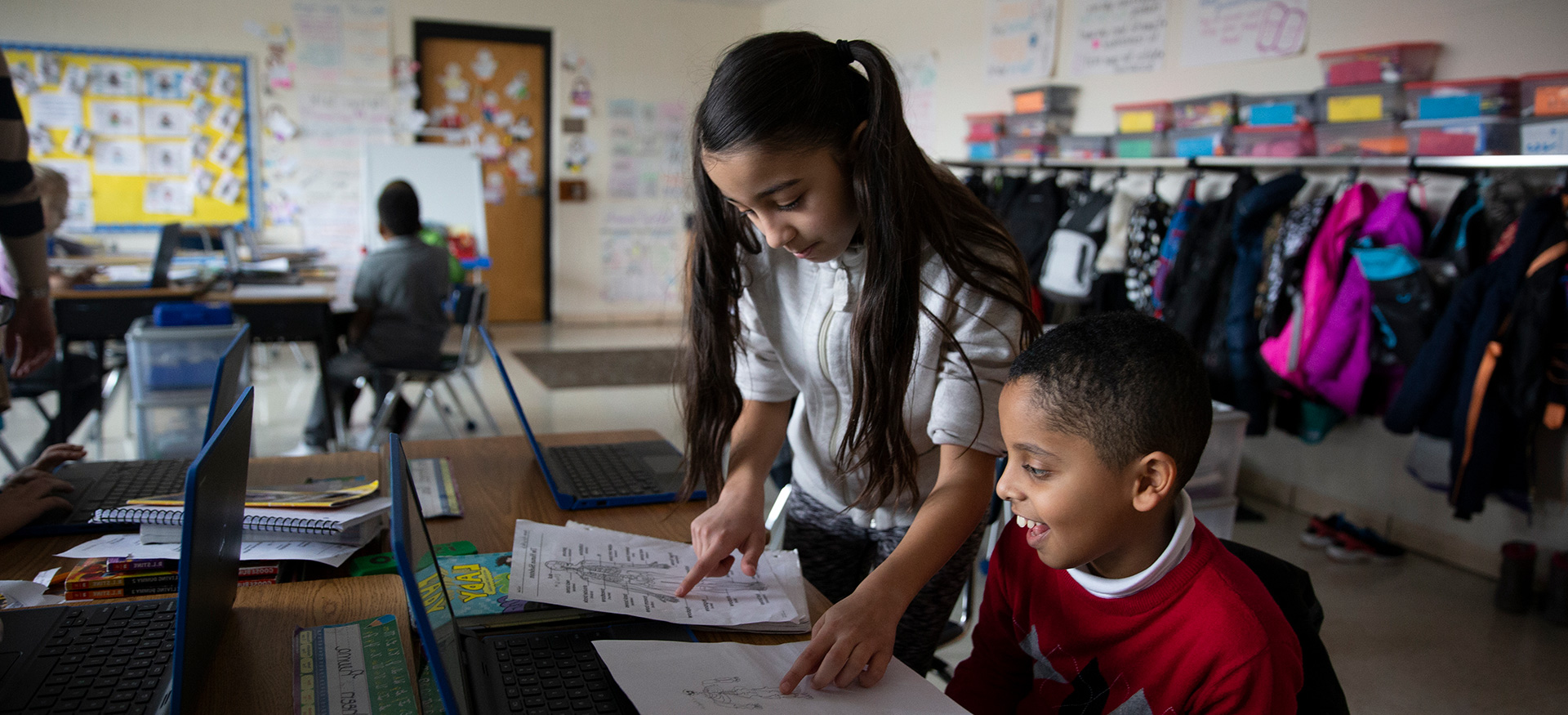 Student helping another student with their work.