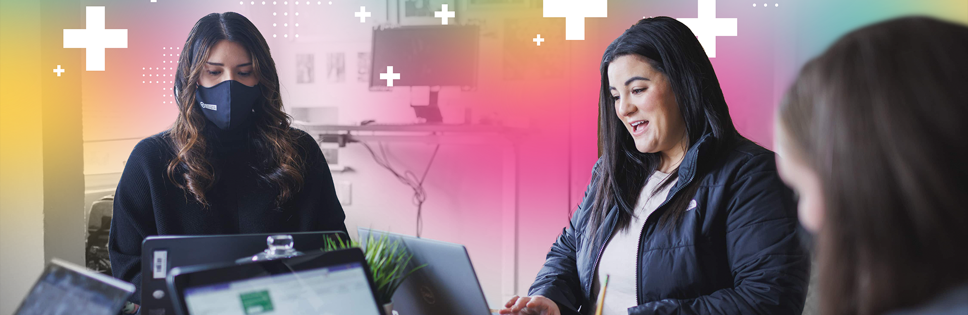 Women at desk with laptops